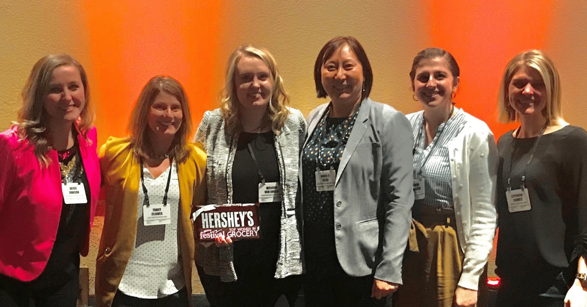 Group of six women smiling at conference