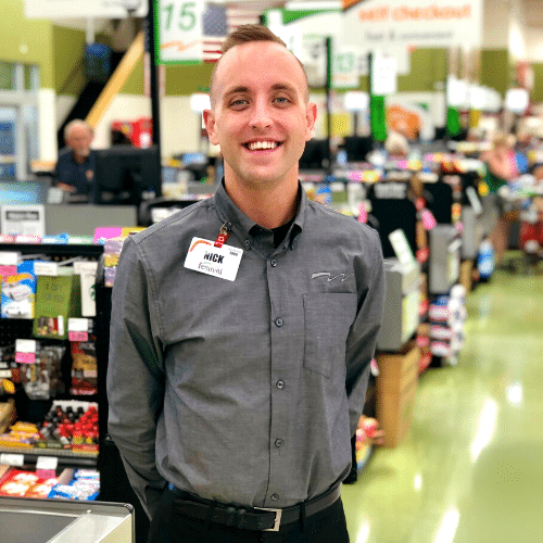 man standing near cash registers